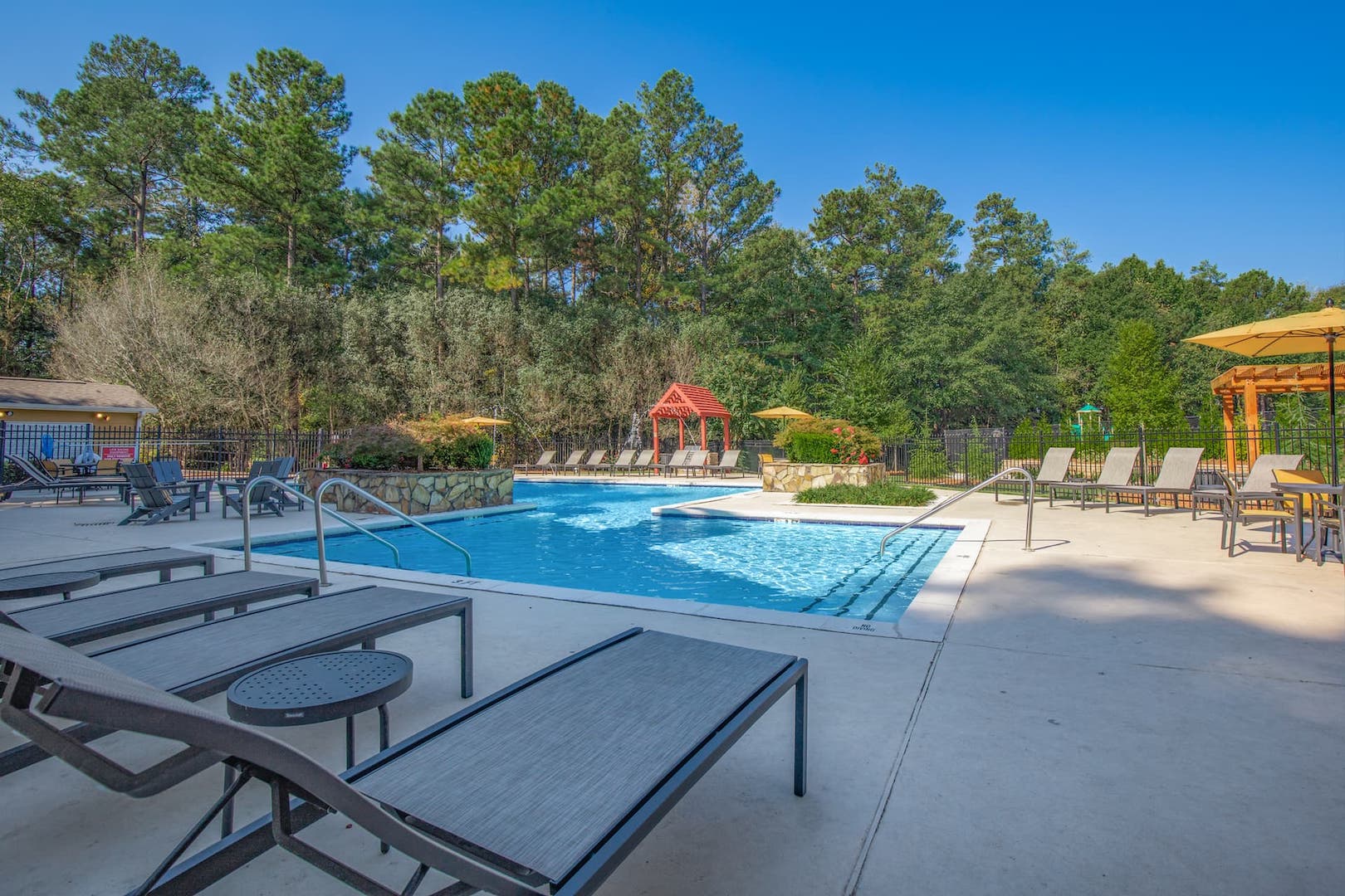 Sparkling Swimming Pool with chaise lounges and shade pergola