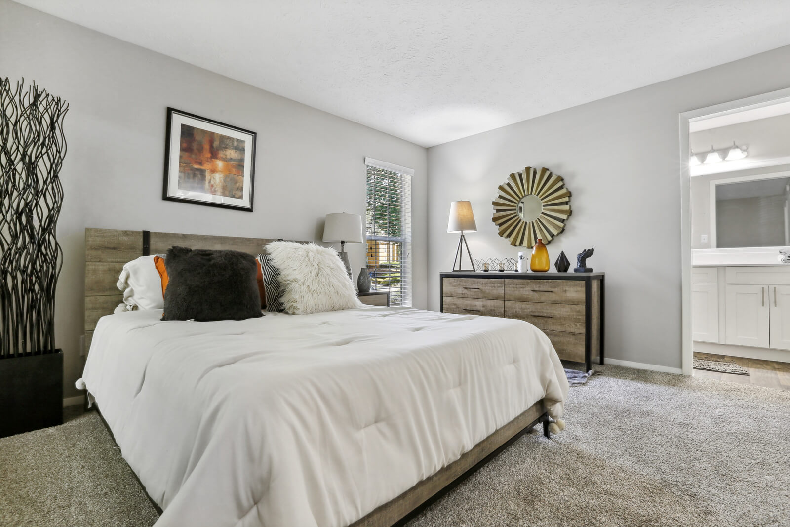 carpeted model bedroom opens to bathroom