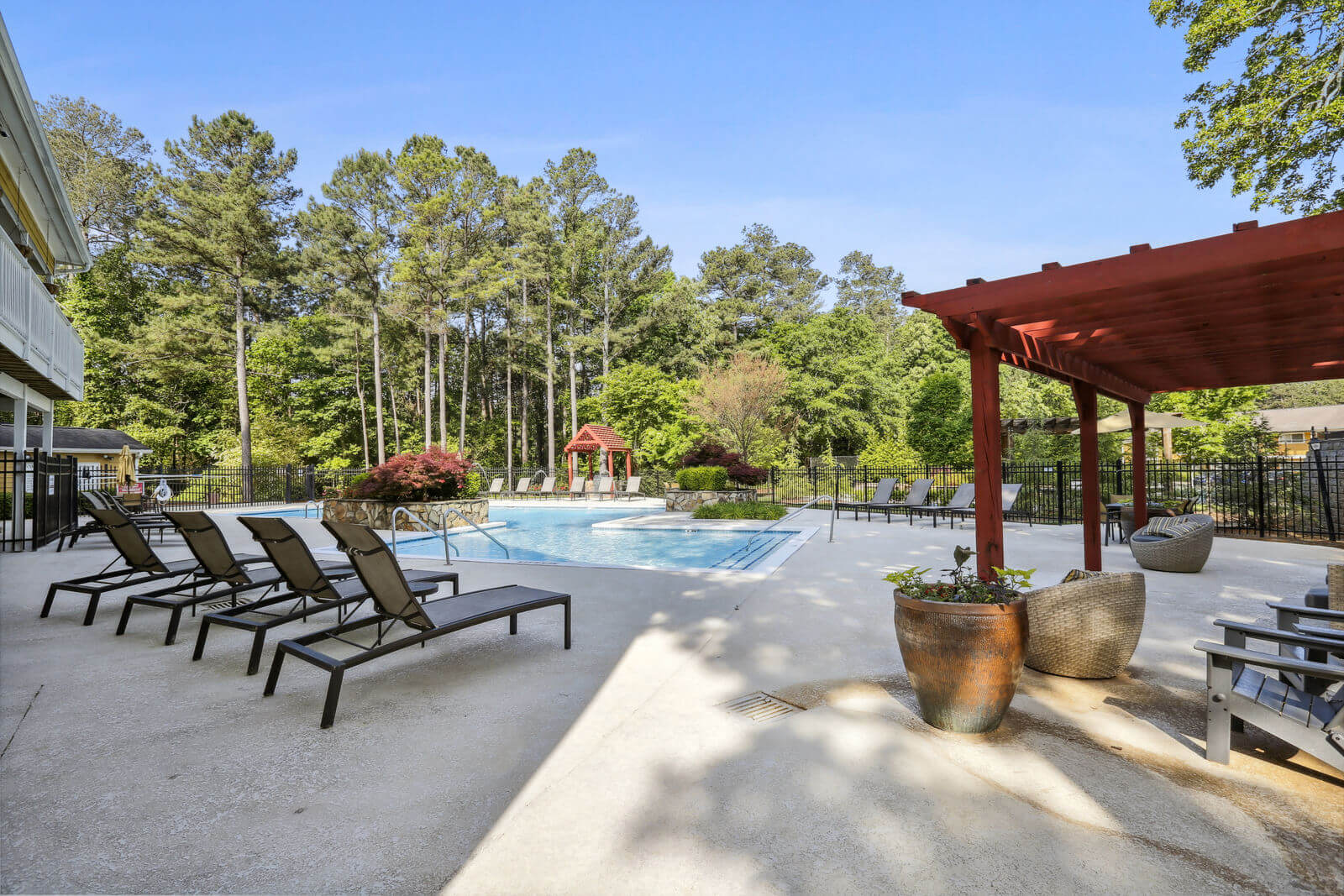 Sparkling Swimming Pool with chaise lounges and shade pergola
